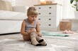 © New Africa - Little girl putting on soft tights at home. Space for text