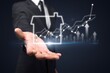 © BillionPhotos.com - Businessman hand holding virtual graph real estate growth.