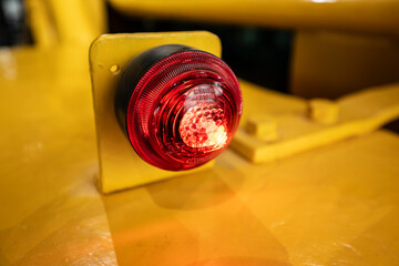 Wall Mural - Red light on a yellow construction machine.