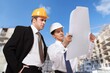 © BillionPhotos.com - Two Architect worker discussing building plan at construction site