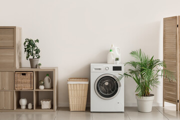 Wall Mural - Interior of light laundry room with washing machine, basket and shelf unit