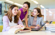 © JackF - Three young women preparing for exams together in a public library