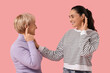 © Pixel-Shot - Women with hearing aids on  pink background