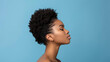 © ChimE - A striking closeup of a young black woman showcasing her beautiful afro hair, radiating confidence and charm.