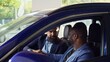 © DC Studio - Happy customers shaking hands with car showroom salesman after finishing test drive and being satisfied. Clients reaching agreement with agent in dealership after driving vehicle, camera B