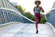 © Raymond Forbes LLC/Stocksy - Female black athlete stride running outdoors in Boston bridge