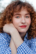 © Viktor Solomin/Stocksy - A young woman with curly hair outdoor closeup portrait
