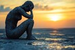 © Minerva Studio - Sad woman covered in mud sitting on beach at sunset