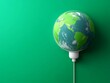 © pornthip - Green Earth Globe Plugged In  Sustainable Energy Concept