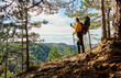 © Boris Jovanovic/Stocksy - Man takes photos from a mountain viewpoint