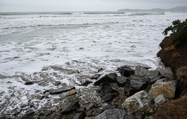 Wall Mural - Waves crashing over rocks ocean rough east coast new zealand oamaru