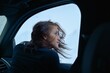 © Studio Sincère/Stocksy - Lady relishing winter air in snowy car
