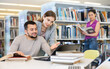 © JackF - Guy and a girl students, preparing for the university library for the exam, are engaged on a laptop, discussing important ..issues of study