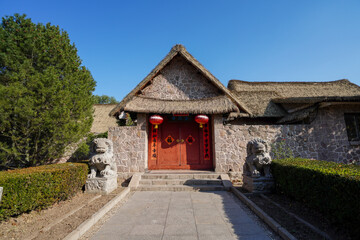 Wall Mural - Scenery of Han Sea Grass Stone House in China Ethnic Museum