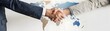 © Sansern - Global business partnership handshake representation professional setting collaborative spirit