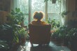 © Tatyana - Smiling woman indoors sitting on vintage armchair holding smartphone surrounded by plants