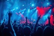 © PP Creative - A lively concert scene with a large crowd of people raising their hands in the air