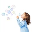 © tanavut - A young child blows bubbles, creating a playful and whimsical atmosphere with colorful, floating soap bubbles around them.