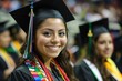© InfiniteStudio - Young hispanic female graduate smiling proudly during her graduation ceremony at an indoor venue in spring
