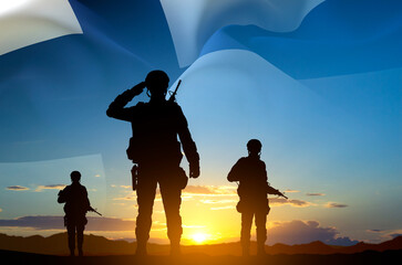 Wall Mural - Silhouettes of a soldiers against the sunset and Finland flag. National Holidays concept