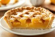 © NayaiP - Close-up of a golden peach pie slice with a lattice top, showing the juicy filling.