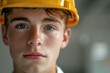 © Alla - Young construction worker wearing a hard hat on site, ready for work