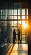 © Maria - Silhouettes of Success: Two businessmen stand silhouetted against a breathtaking sunset, their handshake symbolizing a successful partnership and promising future.