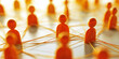 © Nick Freund - Stilisierte orangefarbene Menschenfiguren bilden ein vernetztes Knotensystem, Symbol für soziale Verbindungen und Gemeinschaft, Teamwork