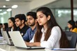 © Jiraphat - A focused group of young adults seated at laptops, engaging in a learning environment, showcasing collaboration and concentration.