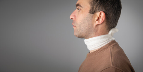 Canvas Print - Caucasian man with a bandage on neck.