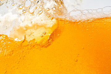 Wall Mural - Close up bright orange Oil or beer splash texture and nature waves, Beautiful waves curve and little bubbles smooth for graphic design and background, Oil Bubbles, Soft beer bubbles, Selective focus