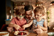 © Davor - Father and kids enjoying messy pancake breakfast together