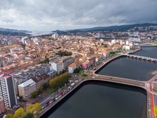 Wall Mural - Aerial drone perspective of Pontevedra city. Famous travel destination in Galicia. River Lerez. Downtown of Pontevedra. Panoramic view of all region. Famous travel destination in Spain.