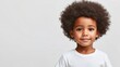 © Nattapol - Adorable black boy with afro hairstyle studio portrait bright mood