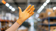 © Tingting - Close-up of worker's hand holding protective glove, symbolizing labor rights and safety in industrial environment.