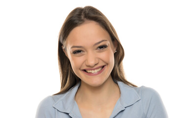 Wall Mural - Portrait of a beautiful young happy woman with makeup on a white studio background