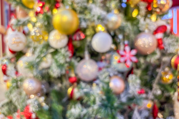 Wall Mural - Abstract Christmas holiday with festive gold bokeh light on Christmas tree blurred background