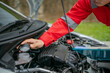 © Odua Images - A mechanic inspects the engine coolant level in a cars engine bay for safety and function