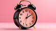 © Chiranjit - Black alarm clock isolated on pink background