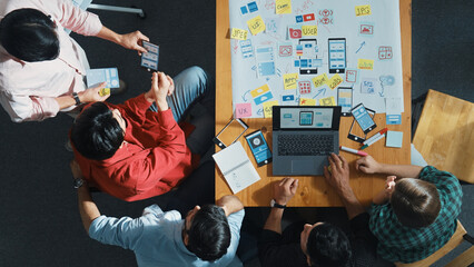 Poster - top view of project manager using laptop working on ux ui design for mobile phone interface while ma