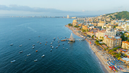 Wall Mural - Panoramic View of the City of Puerto Vallarta from Los Muertos Beach. Pier at Sunset, Banderas Bay. Copyspace