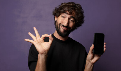 Poster - young bearded crazy man with a smartphone