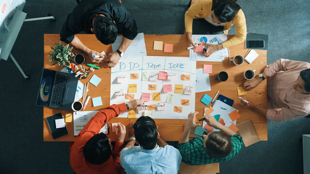 top down aerial view of business team making scrum task board at meeting room. group of people writi