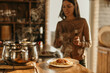 © La Famiglia - Couple cooking together in a bright kitchen, smiling as they prepare fresh pasta with sunlight streaming in