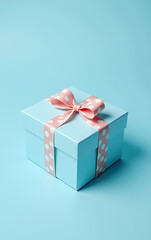 Poster - A blue giftbox sits wrapped in pastel paper with a polka dot design, tied with a ribbon bow on a light blue background._00001_