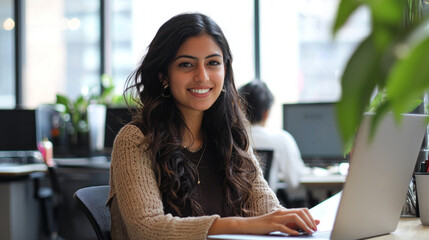 Aufkleber - A skilled IT specialist sits at a stylish desk in a vibrant workspace, focused on her laptop. Lush plants decorate the area, enhancing the atmosphere of creativity and productivity during daylight