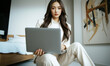 © RooftopStudioBangkok - business woman in white suit working on laptop in modern room, exuding professionalism and focus. stylish decor enhances atmosphere