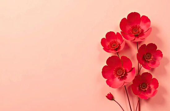 Red paper flowers on a pink background, space for text on the right side