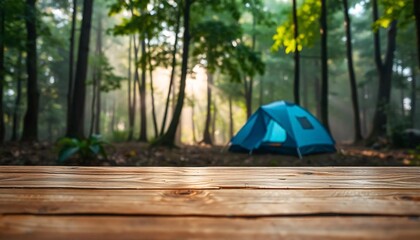 Wall Mural - A empty wooden table in the foreground with a tent and trees in the blurred background, suggesting an outdoor camping scene in a forest