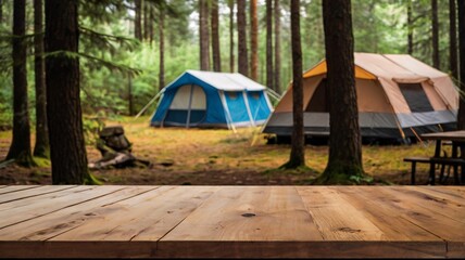 Wall Mural - A empty wooden table in the foreground with a tent and trees in the blurred background, suggesting an outdoor camping scene in a forest